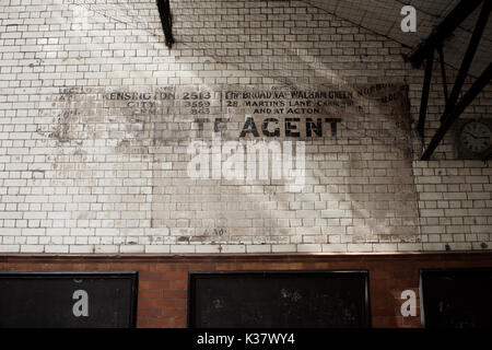 Überreste einer alten Werbeschild an der Wand von Fulham Broadway U-Bahnstation in London Stockfoto