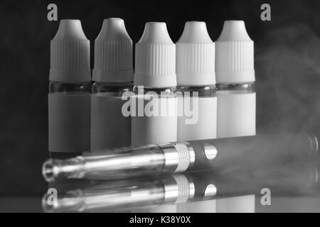 E liquid Flaschen für vaping Geräte, e Zigarette, elektronische Zigarette, über einem schwarzen Hintergrund. Stockfoto