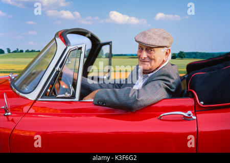 Wohlhabende Ältere in rot-Oldtimer Jaguar XK 150 Cabrio Stockfoto