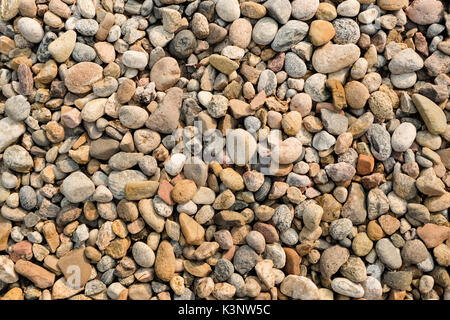 Nahaufnahme von gerundet und poliert Strand Felsen Hintergrund Stockfoto