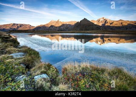 Peaks Tambò und Piani sind im See Andossi bei Sonnenaufgang Chiavenna Tals Veltlin Lombardei Italien Europa wider Stockfoto