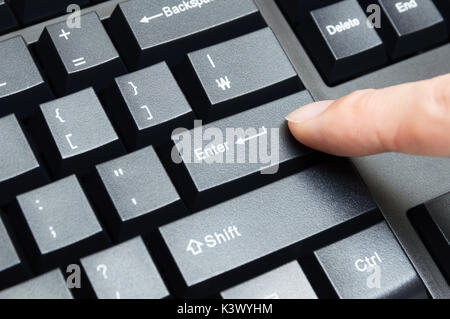 Männliche finger Drücken der Taste enter Stockfoto