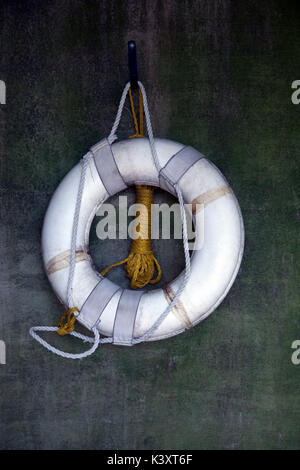 Vertical image of a white life preserver on a wall Stockfoto