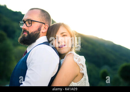 Braut und Bräutigam in romantische Umarmung bei Sonnenuntergang Zeit Stockfoto