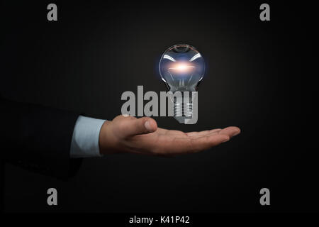 Händen der Unternehmer mit beleuchteten Glühbirne Schild Stockfoto