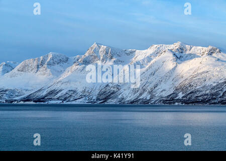 Blauer Himmel und schneebedeckten Gipfeln umgeben das kalte Meer Lyngen Alpen Tromsø Lappland Norwegen Europa Stockfoto