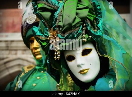 Ein paar kostümierte Maskeraden in grün Kostüme beim Karneval von Venedig Stockfoto