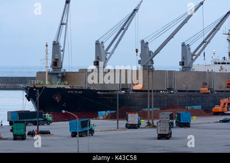 Uniplus bulk carrier Kränen entladen Lasten mit Kipper Warten auf Laden, Hualien Port, Hualien City, Taiwan Stockfoto