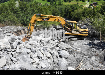 Engelberg, Schweiz - 30. Juli 2017: Digger, ordnet ein Bett eines Flusses nach einem Erdrutsch in Engelberg in den Schweizer Alpen Stockfoto