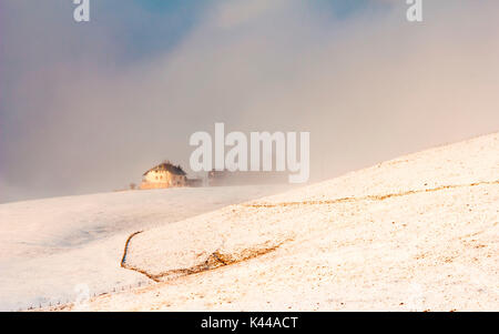 Hochebene von Asiago in der Provinz Vicenza, Venetien, Italien. Bauernhaus im Winter Nebel. Stockfoto