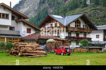 Große Häuser mit Haufen von Rundholz für Heizung im Winter, Sölden, Sölden Österreich Stockfoto