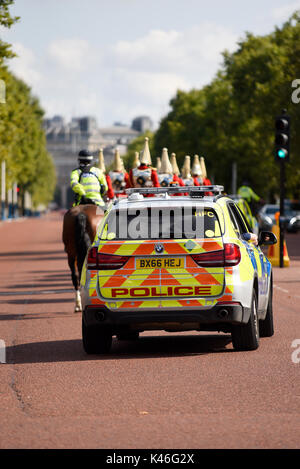 Die Polizei-Sicherheitseskorte für den Wechsel der Wachzeremonie montierte Soldaten der Life Guards der Household Cavalry in Der Mall, London, Großbritannien Stockfoto