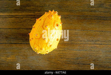 Gelbe kiwano Melone auf hölzernen Tisch von oben betrachtet isoliert Stockfoto