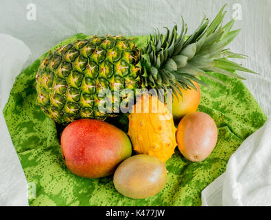 Tropische Früchte auf einem grünen Tuch von oben gesehen Stockfoto