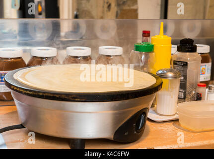 Vorbereitung eines französischen Snack bestehend aus einem salzigen Krepp, auch als "galete" bekannt. Auch Süßes mit Schokolade verteilt. Stockfoto