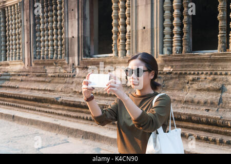 Weibliche Reisende unter Foto mit Ihrem Smartphone in Angkor Wat siem reap Kambodscha Stockfoto