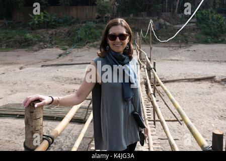 Frau stehend auf Bambus Brücke, Fluss Nam Khan, Luang Prabang, Laos Stockfoto