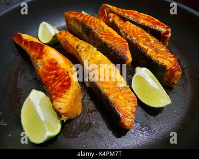 Nahaufnahme von saftigen Lachsfilets Braten mit Zitronenscheiben Stockfoto