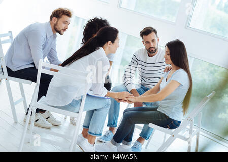 Professionellen, freundlichen Arzt hält ihre Patienten die Hände Stockfoto