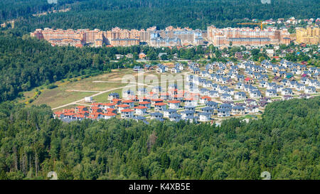 Oben Blick auf moderne Cottages und Apartments Häuser im grünen Wald der Region Moskau in Opaliha Bezirk der Stadt Krasnogorsk Stockfoto