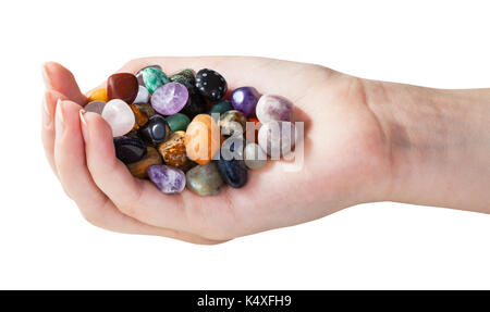 Handvoll mit verschiedenen Edelsteinen auf weißem Hintergrund Stockfoto