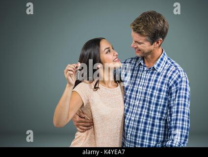 Digital composite von Paar Gedrückthalten der Taste vor Vignette Stockfoto