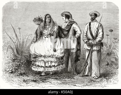 Zwei yucatan Mann und eine Frau, die den ganzen Körper in ihrer traditionellen Kleidung posiert in der Nähe von kleine, typisch mexikanischen Vegetation. Von Riou nach Charnay auf Le Tour du Monde Paris 1862 veröffentlicht erstellt Stockfoto