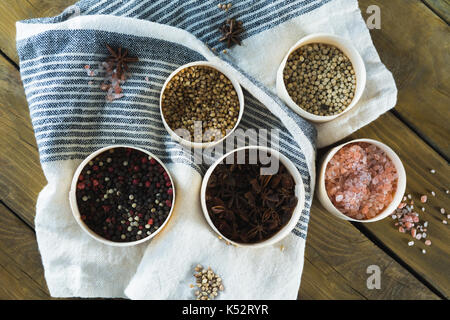 Verschiedene Gewürze in Schale auf Holztisch Stockfoto