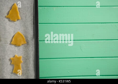 Ansicht von oben der rohen Cookies in Backblech auf hölzernen Tisch Stockfoto