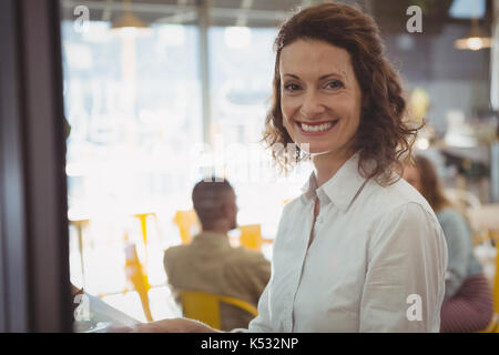 Portrait von Happy Geschäftsfrau im Cafe sitzen Stockfoto