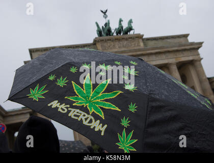 Berlin, Deutschland. 9 Sep, 2017. Ein Mann trägt einen Regenschirm mit Bildern von Marihuana Blätter vor dem Brandenburger Tor in Berlin, Deutschland, 9. September 2017. Foto: Paul Zinken/dpa/Alamy leben Nachrichten Stockfoto