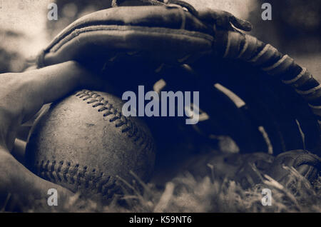 Vintage baseball Handschuh zeigt Spieler Hand greifen den Ball closeup Stockfoto