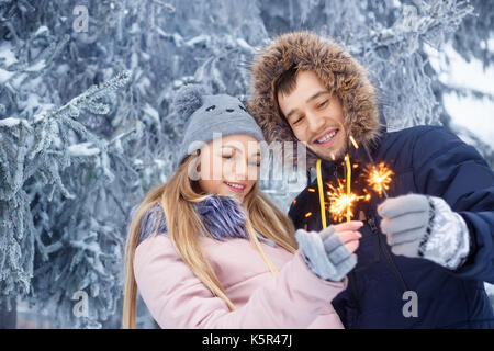 Paar mit Wunderkerzen im Winter Stockfoto