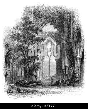 1870: Das kirchenschiff von Tintern Abbey, gegründet von Walter de Clare, Herr von Chepstow, am 9. Mai 1131. Es sitzt auf der Welsh Bank des Flusses Wye, bildet die Grenze zwischen Monmouthshire in South Wales und Gloucestershire in England. Es war nur das zweite zisterzienser Foundation in Großbritannien, und das erste in Wales, aber Verfielen nach der Auflösung der Klöster im 16. Jahrhundert. Stockfoto