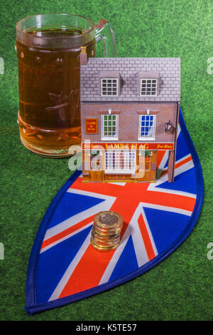 Modell Englischer Pub mit Getränk und ein Union Jack mit neuen lbs-Münzen. Großbritannien Getränke Industrie Konzept, mit Kosten von Unternehmen und Kunden Perspektiven. Stockfoto