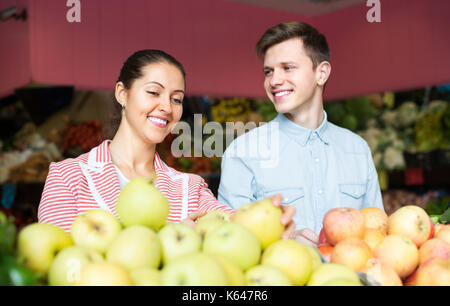 Positive junges paar Sie Obst und Gemüse auf dem Markt Stockfoto