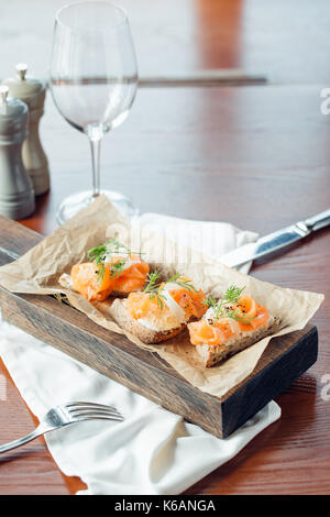Sandwich mit Getreide Brot und Lachs auf dunklem Marmor Stockfoto