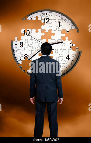 Geschäftsmann vor einem einer Uhr puzzle unvollendet, Zeit weg fliegen Konzept Stockfoto