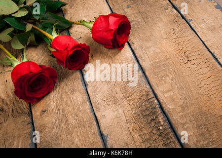 Valentine's Tag drei rote Rosen auf alten Holztisch Stockfoto