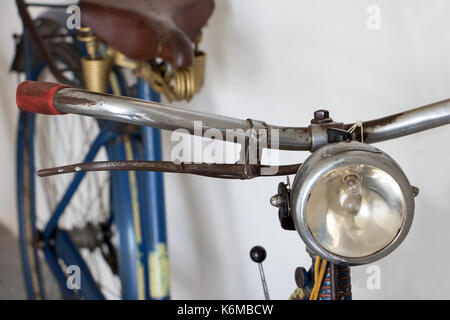 Ein altes Fahrrad lehnt sich gegen eine Wand. Stockfoto