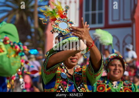 Tinkus-Tänzer gekleidet in prunkvollen Kostümen, die Durchführung während einer street Parade an der jährlichen Carnaval Andino Con la Fuerza del Sol in Arica, Chile. Stockfoto