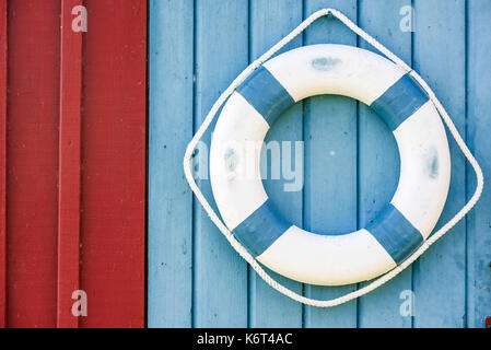 Blau und Weiß Rettungsring hängen auf Holz- wand. Stockfoto