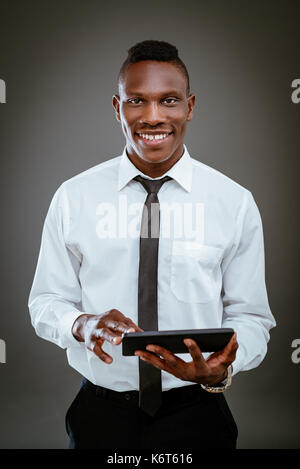 Lächelnd afrikanischen Geschäftsmann Holding digital Tablet und Kamera. Stockfoto