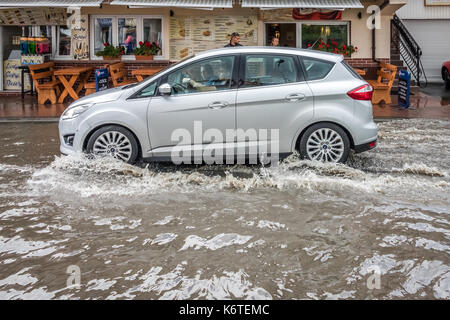 Sarbinowo, Polen - August 2017: Auto, das durch die überschwemmten Straße nach extrem starke Regenfälle Stockfoto