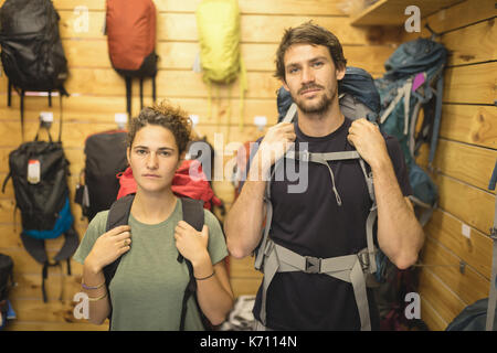 Portrait von zuversichtlich Freunde Rucksäcke kaufen in Store Stockfoto