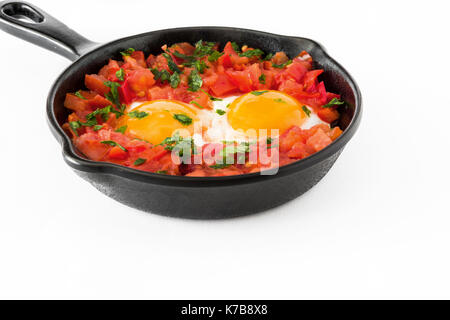 Shakshuka in Eisen Braten auf weißem Hintergrund pan. Typisches Essen in Israel. Stockfoto