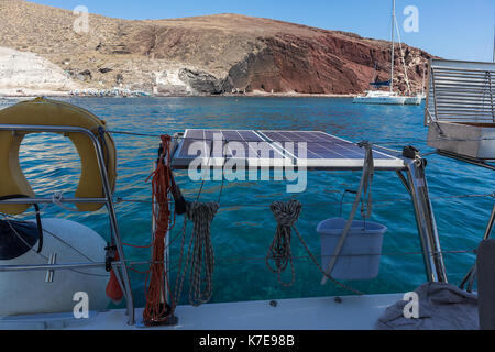 Red Beach in Santorini, Blick auf das Meer mit Katamaran Stockfoto