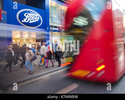 Ein unscharfer-Bus wird durch eine Filiale einer Handelskette in London Stockfoto