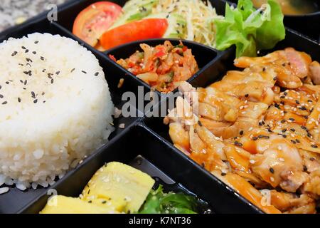 Traditionelle japanische Küche, Bento Box oder Multi-Layered Box mit Teriyaki Huhn Reis, Salat, Tamagoyaki oder gerolltes Omelett, oder Hiyashi Wakame Algen Stockfoto