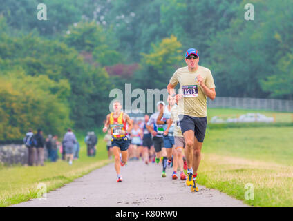 Führende Läufer auf dem Weg über den Damm zu Beginn der Rutland Marathon und Halbmarathon Rennen in Rutland Water Reservoir, England, am Sonntag, den 17. September 2017 Stockfoto